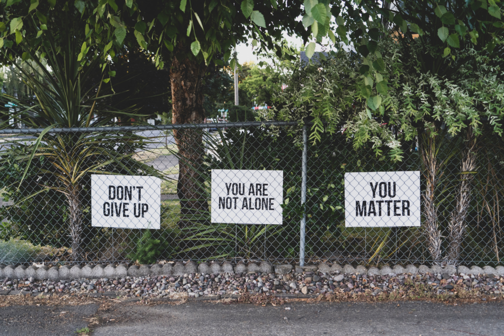 Fence with encouraging signs