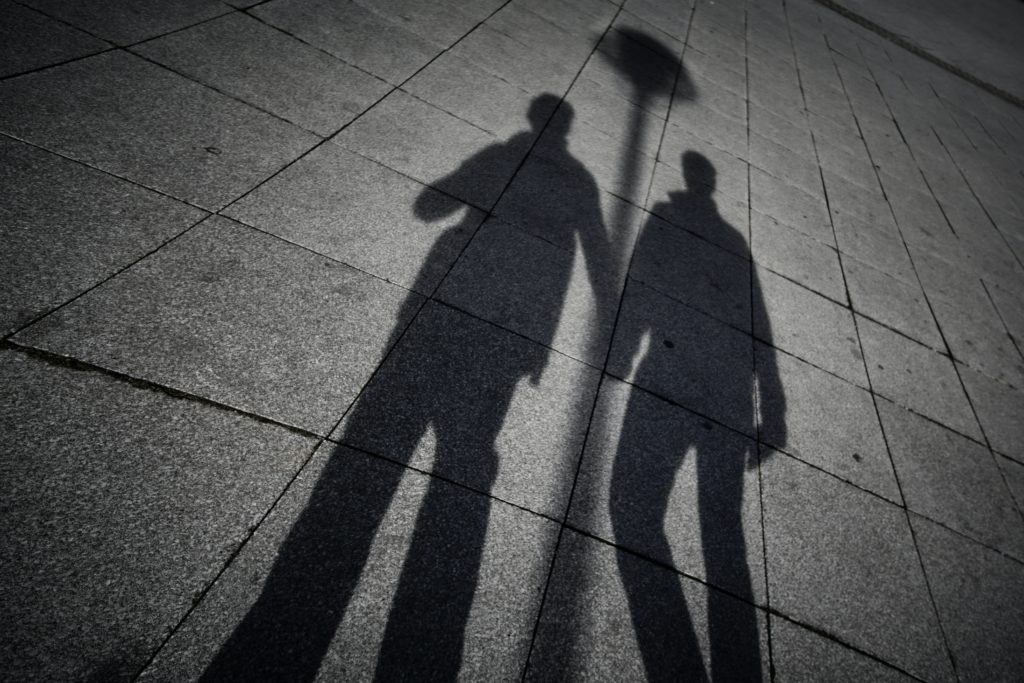 Shadow of two people holding hands
