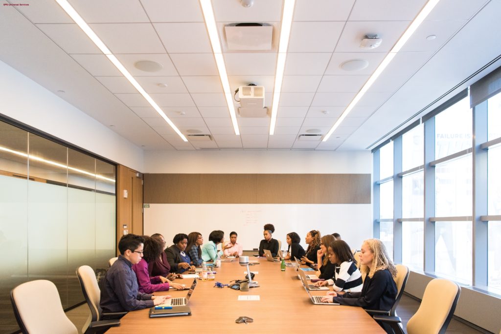 Group of people sitting around a conference table